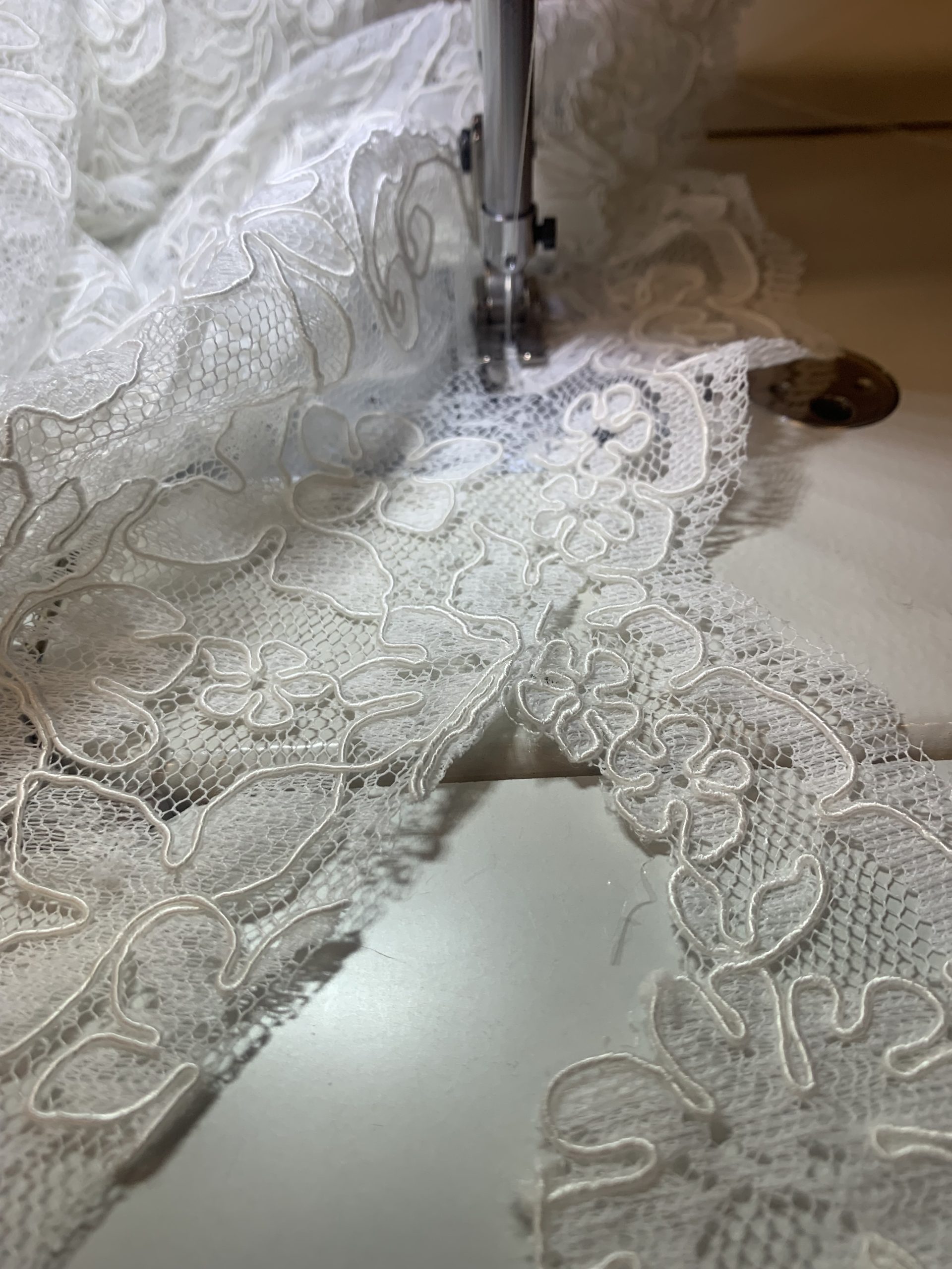 Trim being reattached to wedding dress hem