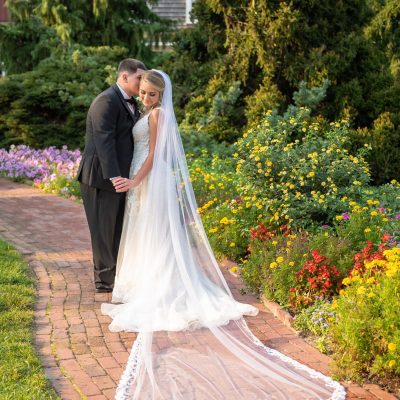 Dress: custom veil, sides taken in, hemmed, and bustle. Suit: tapered suit jacket and pant hem